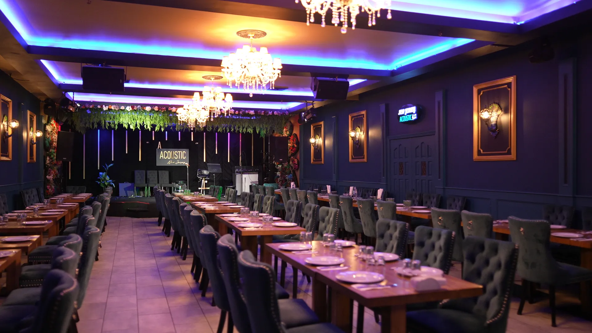 NJ Acoustic dining room with chandeliers, tables, and upholstered chairs